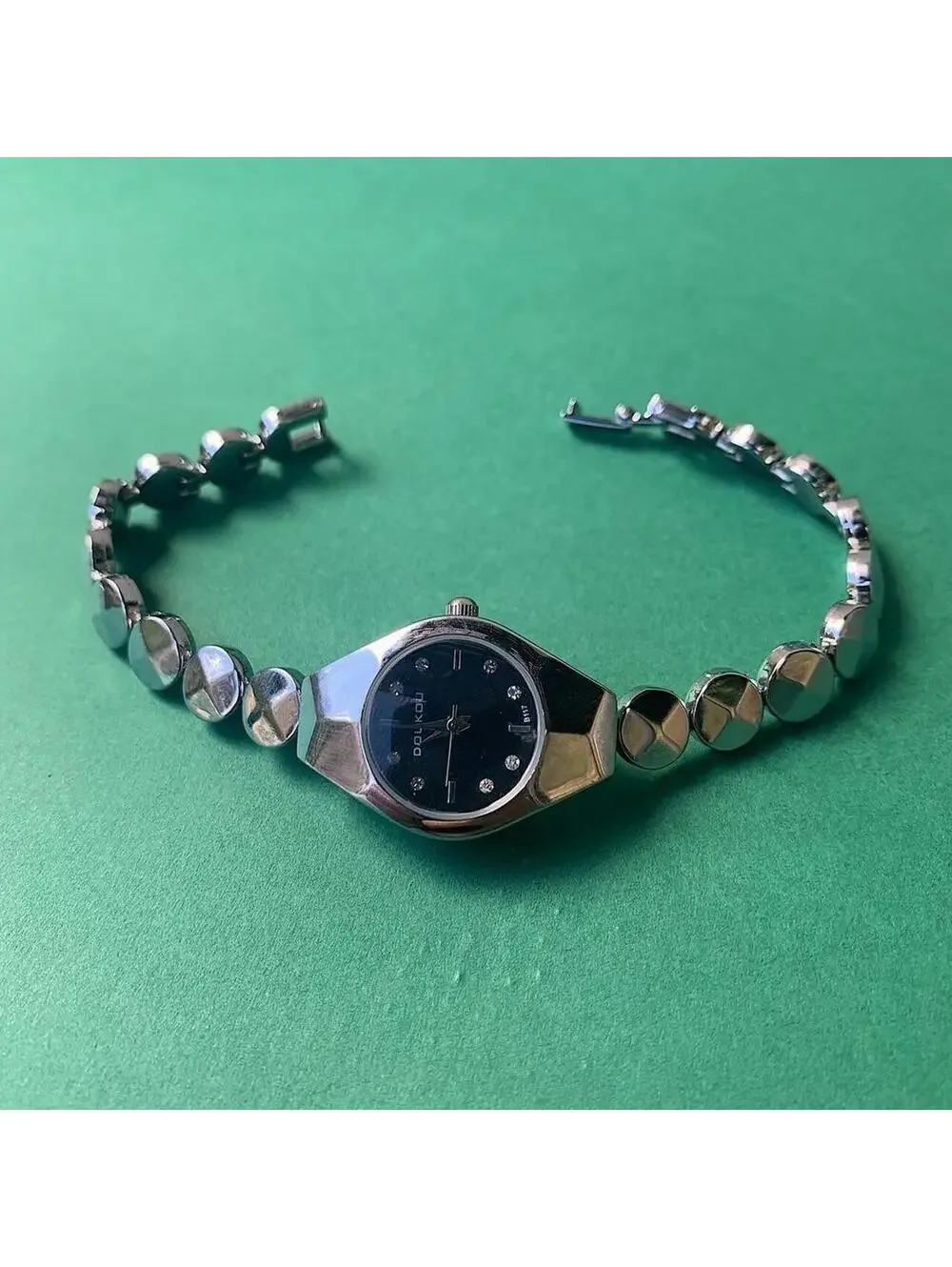 Black and silver watch with a unique design with rhinestones